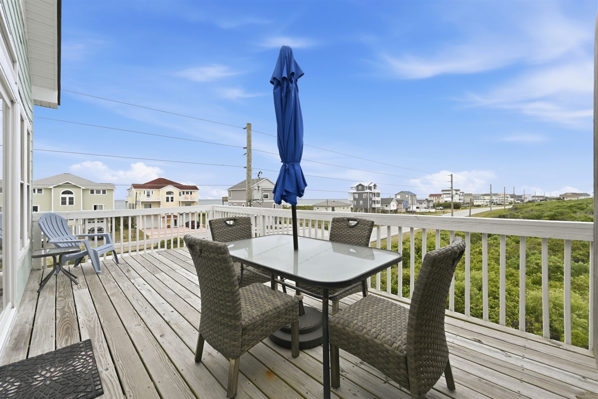 Elevated deck with dining area and neighborhood views
