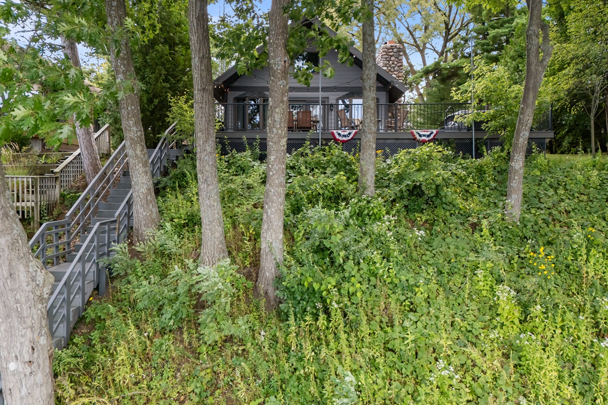 The stairs provide easy access down to the lake, making it simple to enjoy swimming, kayaking, or just dipping your toes in the water