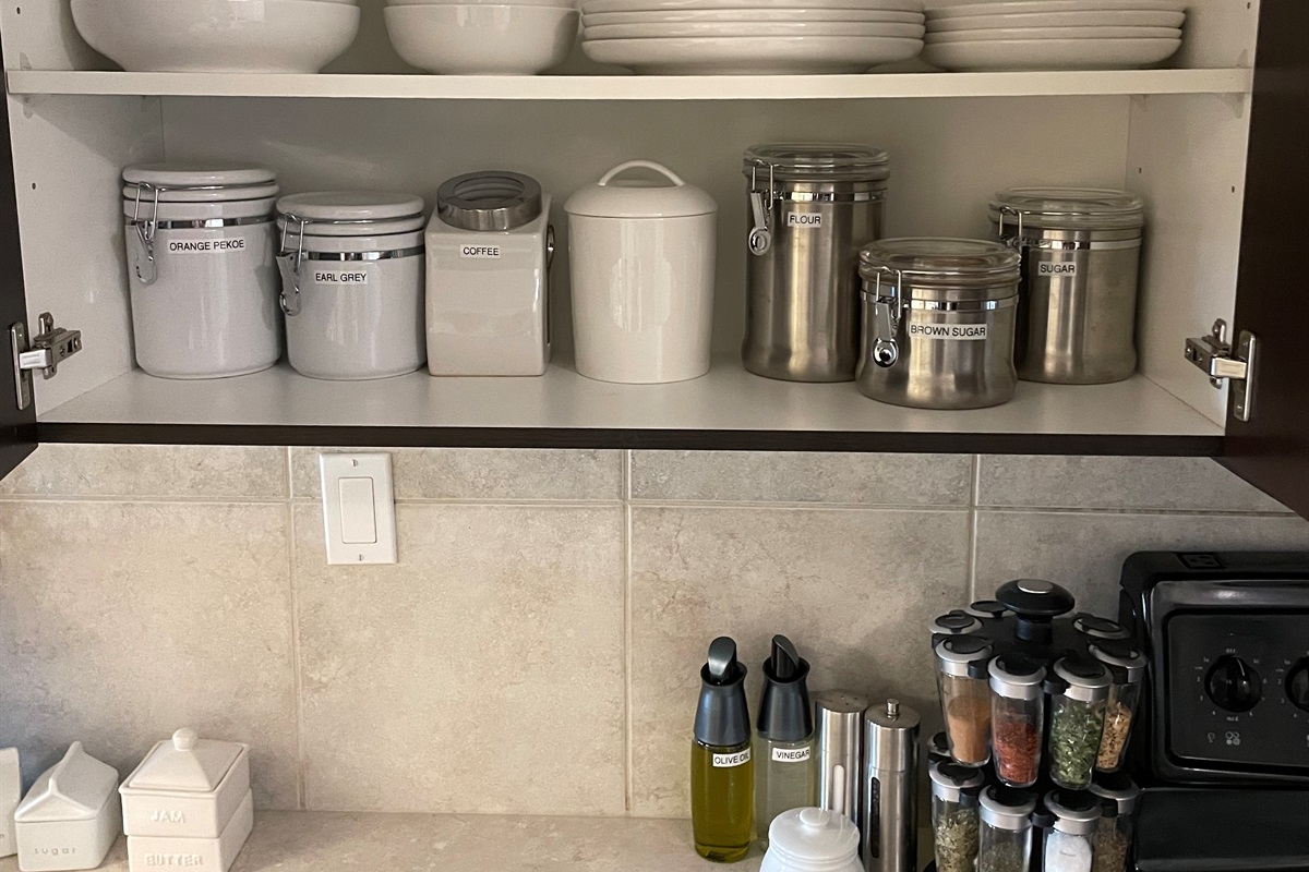 Kitchen stocked with spices and basic supplies.