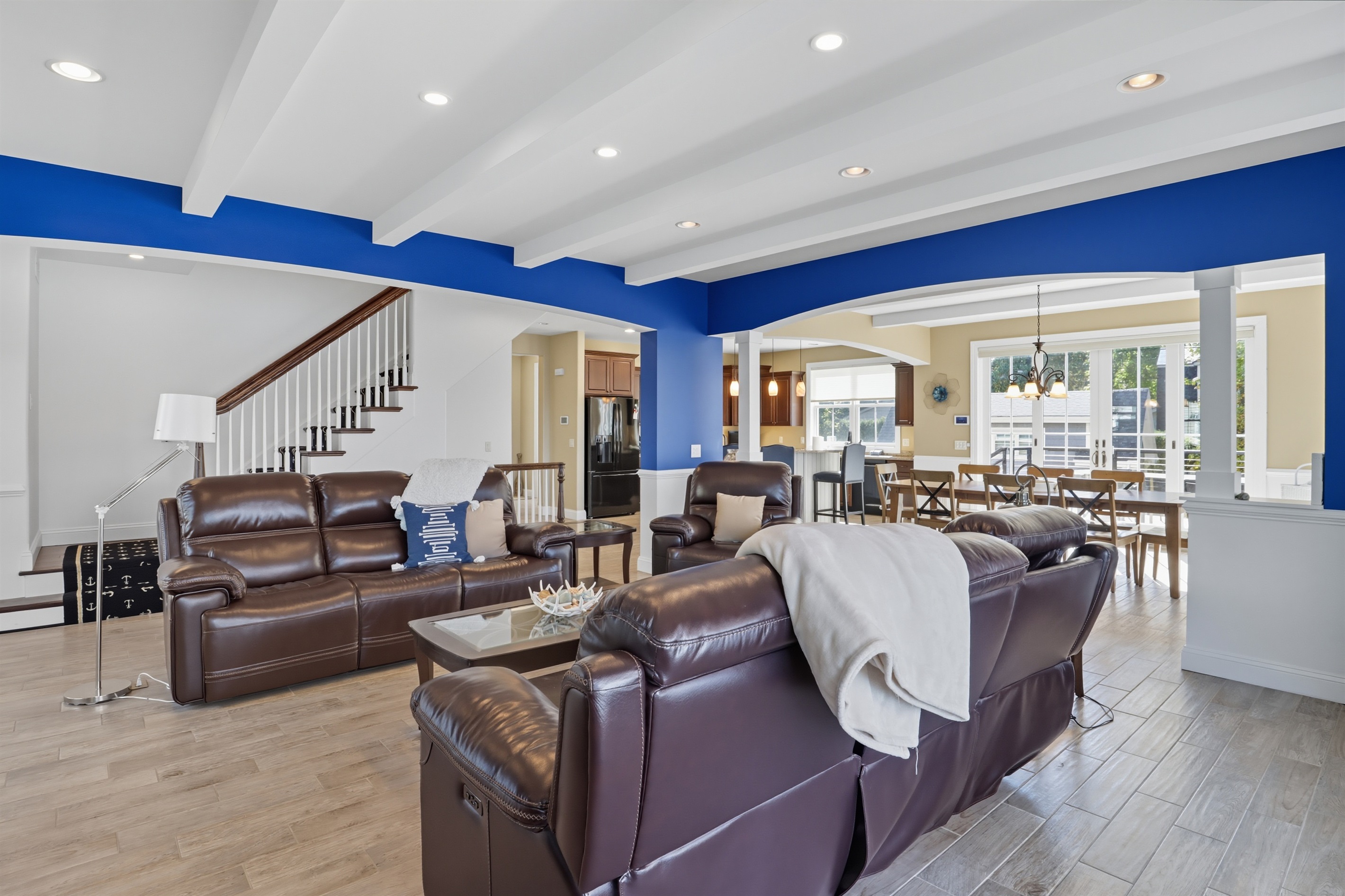 Spacious main floor living room with high ceilings, gas fire place and abundant natural light.