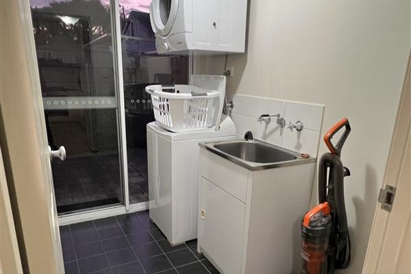 Spacious laundry with top load washing machine & clothes dryer