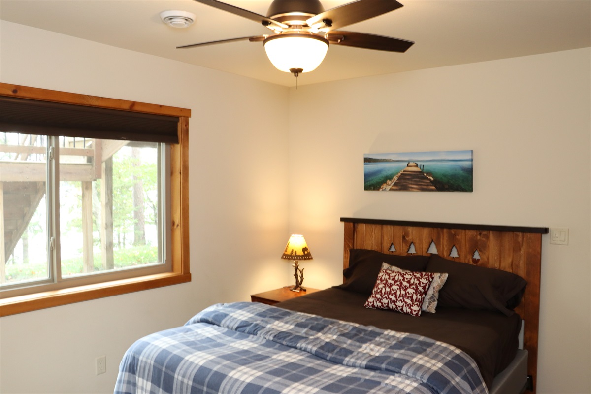 Lower Level Bedroom 5 - Lakeside Views, Queen Bed, Dresser, Nightstand with USB charging ports, Closet.