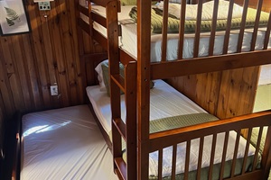 Twin bunk bed with white and green linings