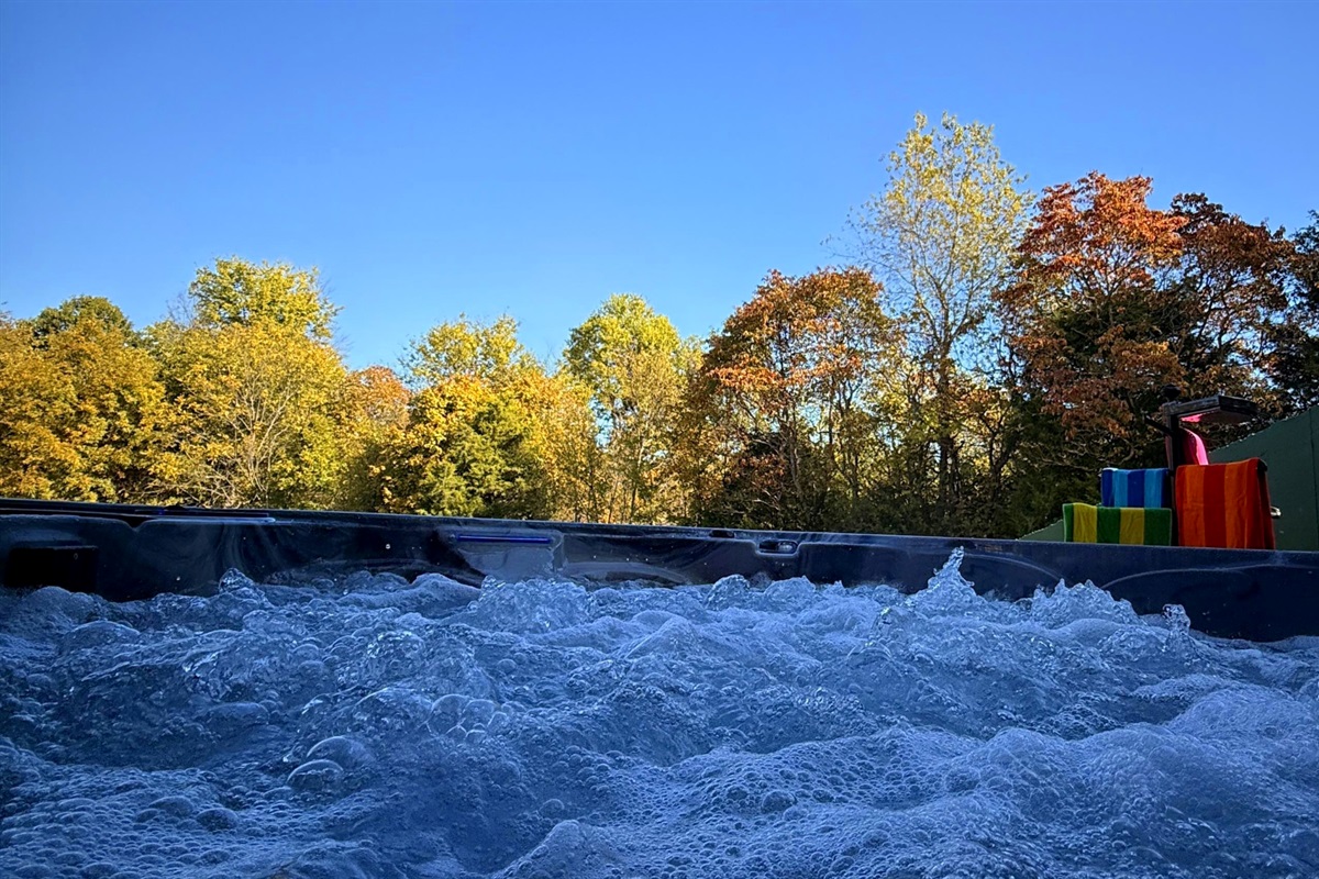 A crisp fall morning beside the hot tub — sunlight, steam, and serenity in the heart of bourbon country.