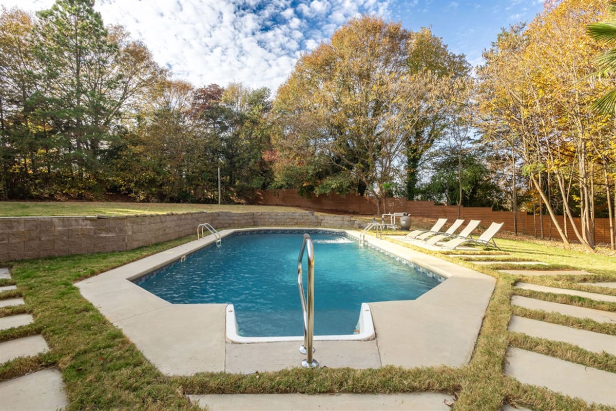 Inviting pool area, perfect for a refreshing swim or lounging in the sun, offering a relaxing outdoor retreat right at your doorstep.