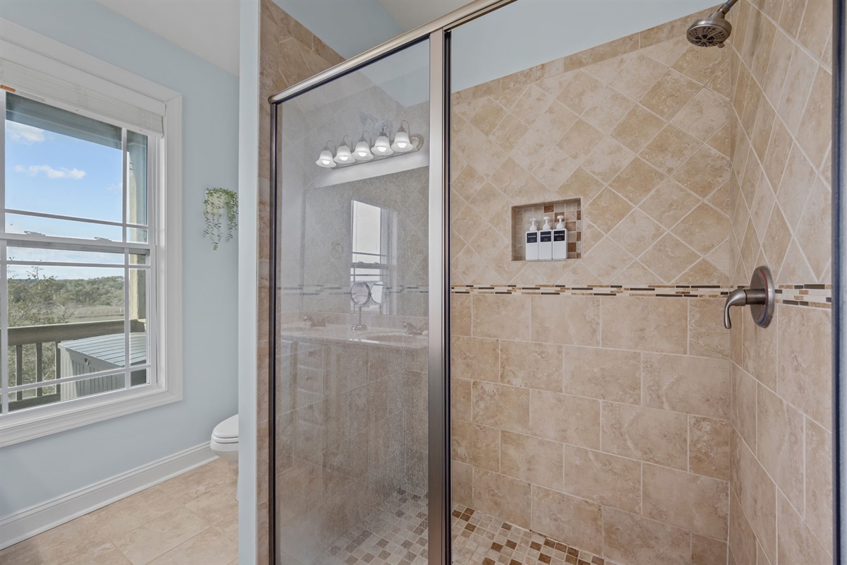 Large master bathroom with walk in shower and views of the sound reminding you that it is just you and nature 