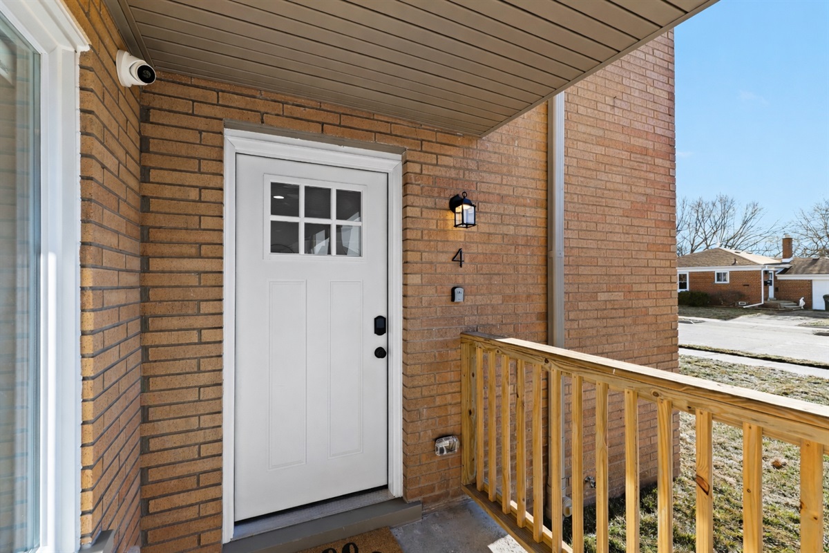 Inviting private entry with a covered porch, secure smart lock, and soft exterior lighting—welcoming you home with charm, comfort, and easy access.