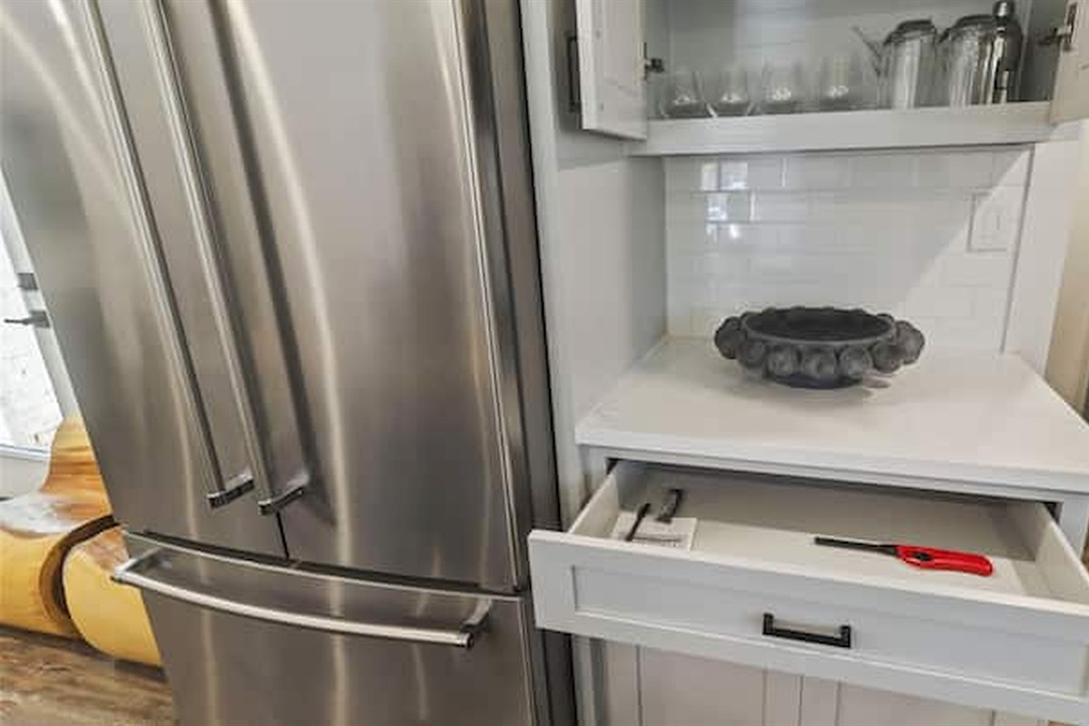 Modern kitchen details with stainless steel appliances and thoughtfully stocked essentials.