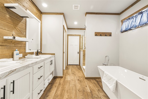 Private primary bathroom with soaking tub and walk in shower