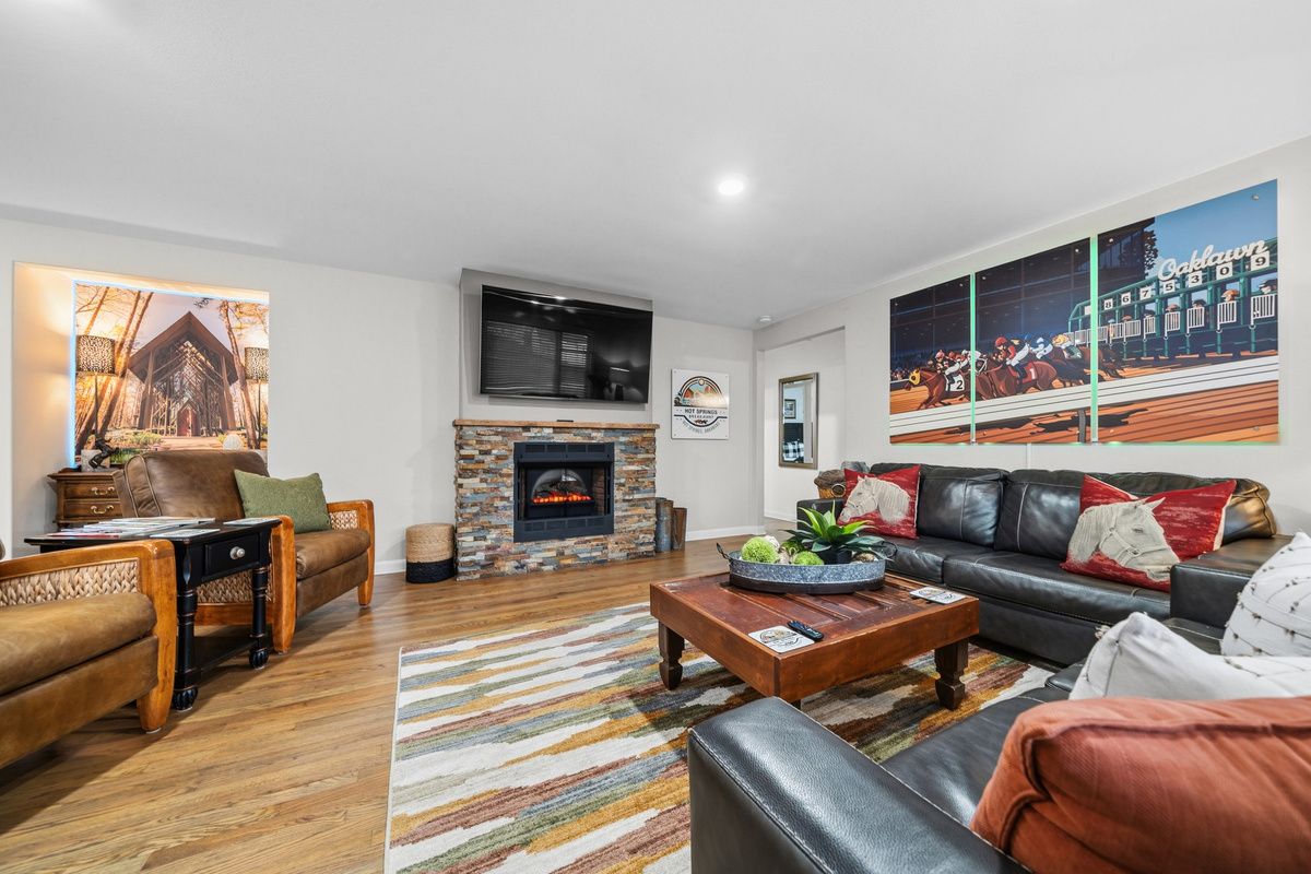 Fold into the couches by the stone fireplace — the main floor opens wide enough for all ten of you to land in one room.