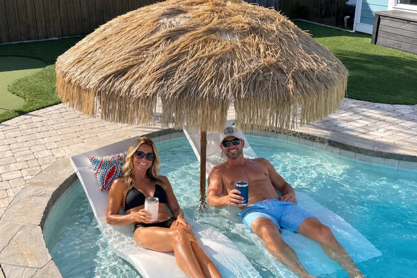 AI-enhanced poolside lifestyle image with digitally added guests. See original property photos for the private pool and outdoor amenities.