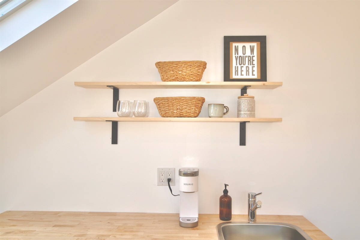 Make coffee or tea with the Keurig (coffee and tea included) and keep a bottle of wine cold in the mini-fridge.