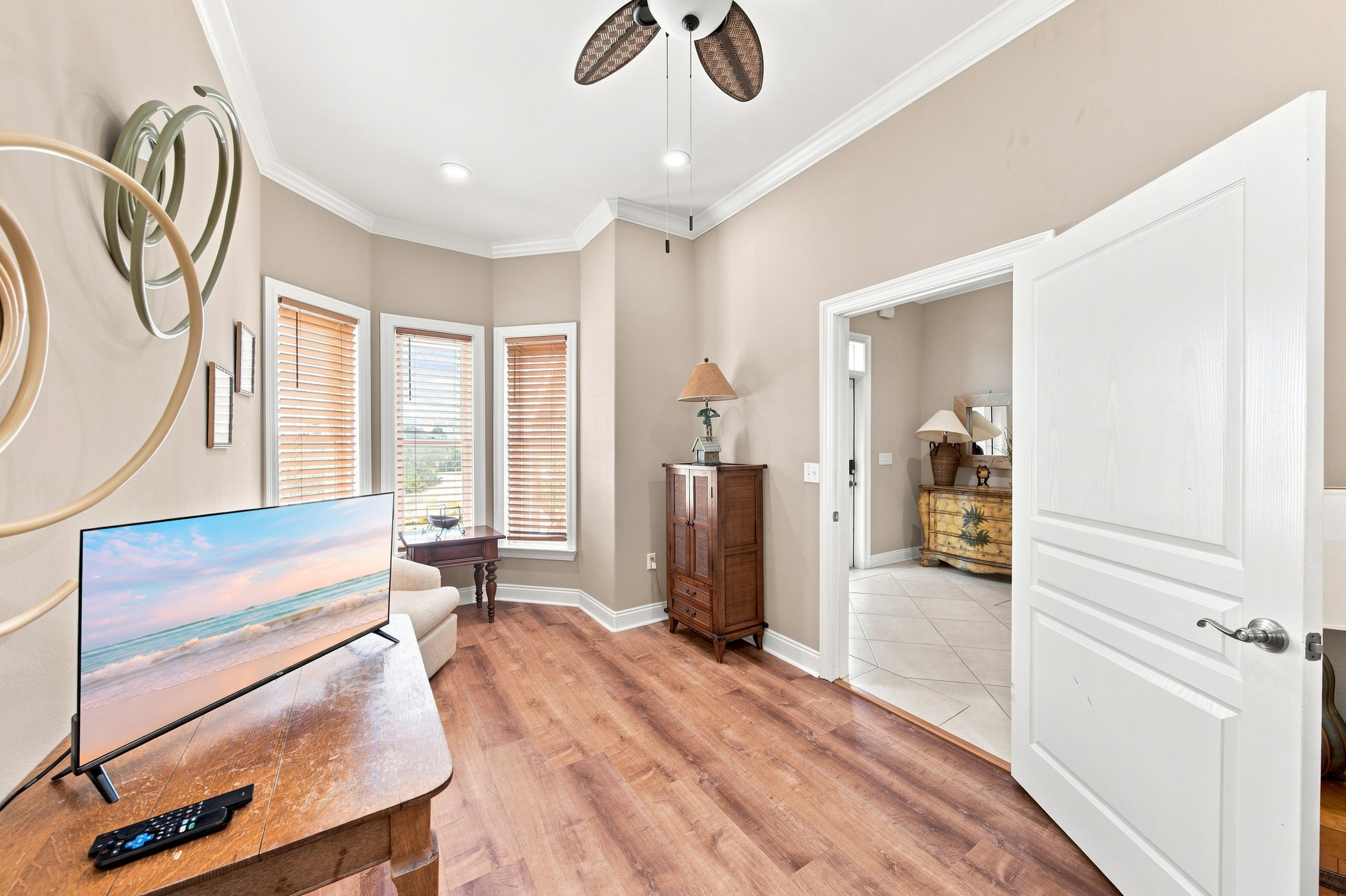 Comfortable bedroom with hardwood floors and natural light