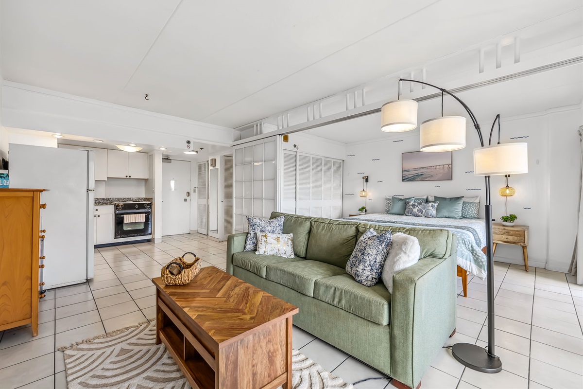 Angle view of open floor plan of living area with bedroom sliding doors left open