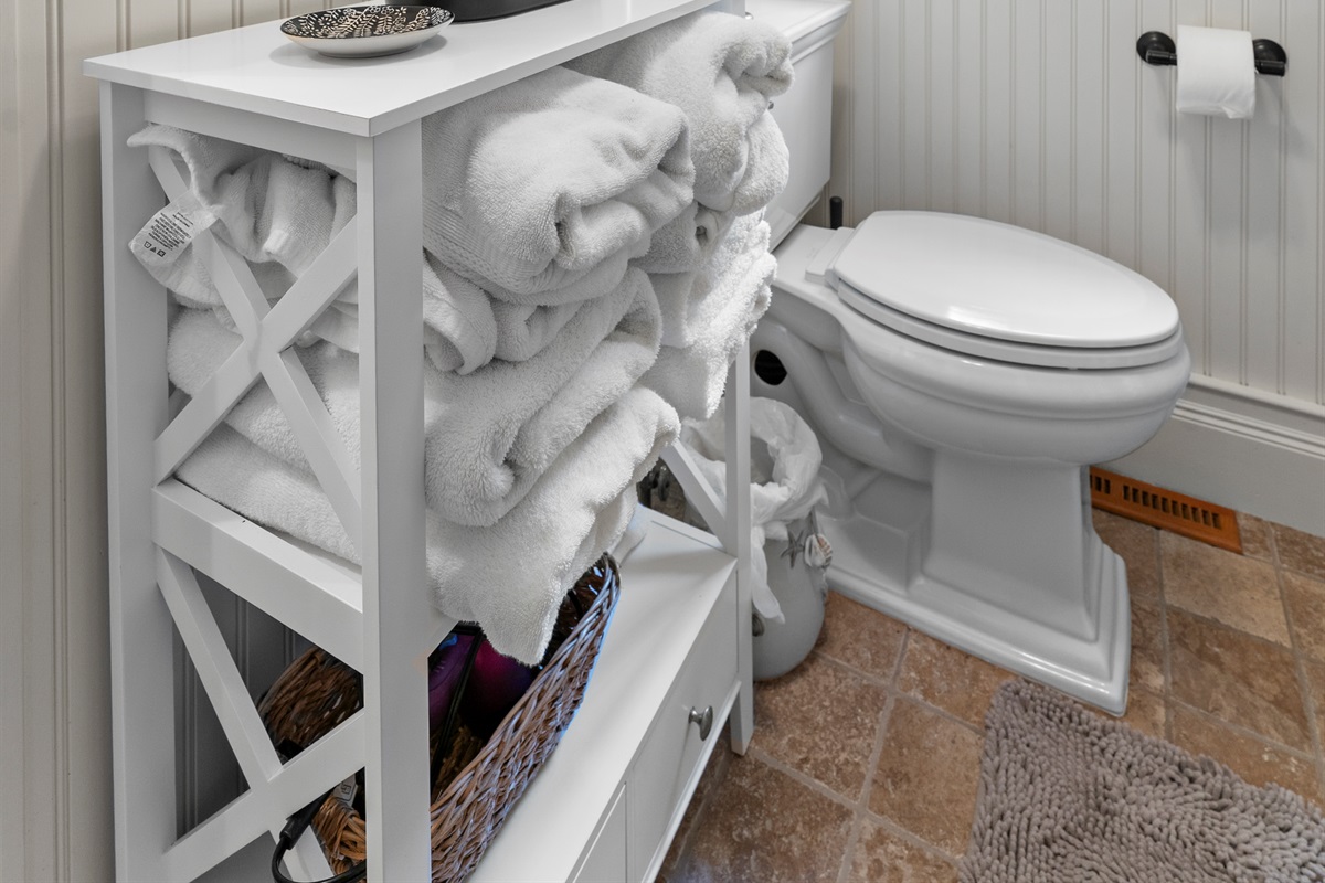 Relax in a warm, inviting bathroom with fluffy towels.