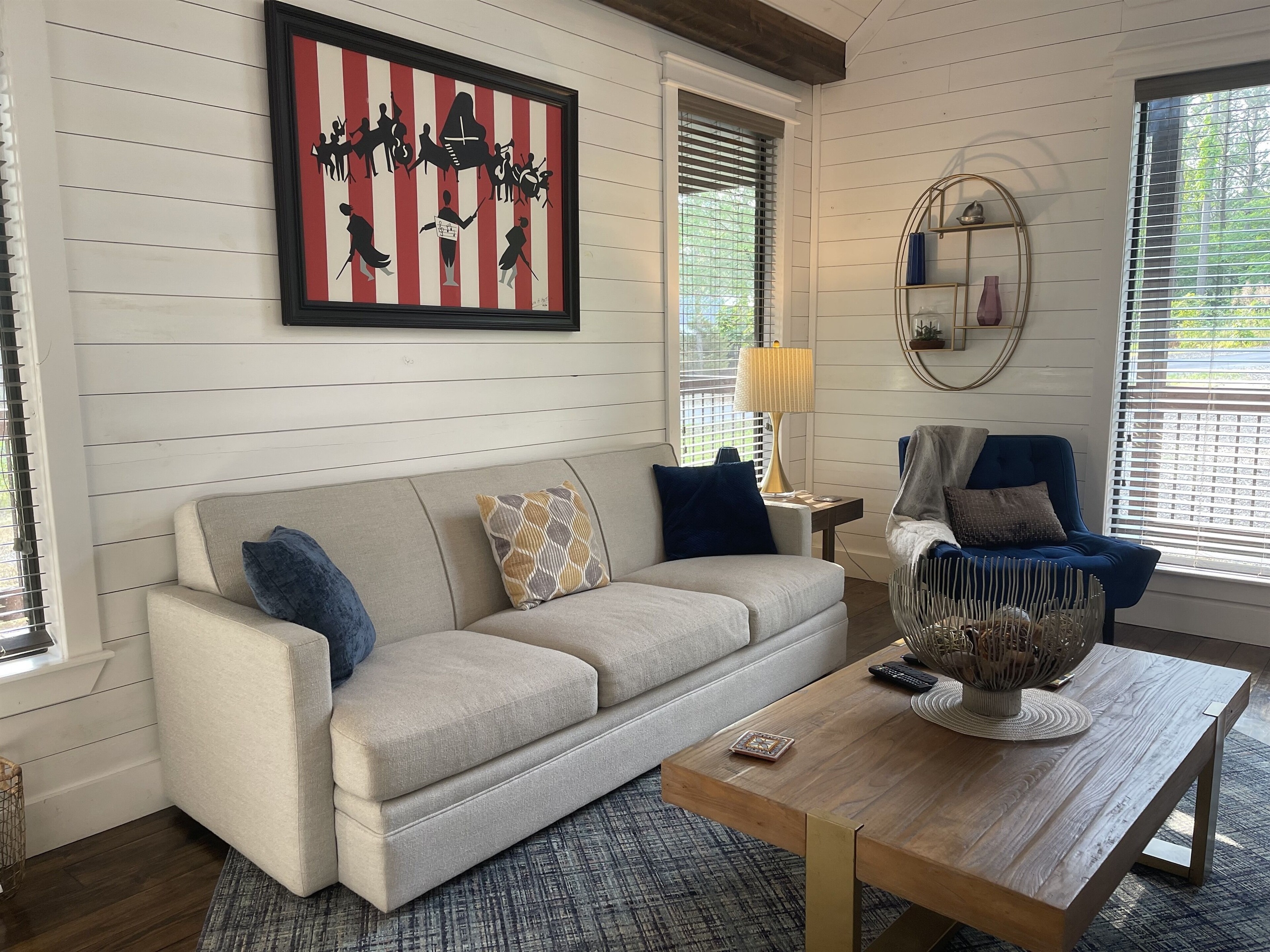 Cozy couch in the living room, and a comfy chair by the window.