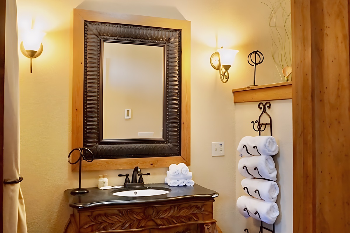 A warm and inviting bathroom, where even the towels are neatly arranged and ready for you.