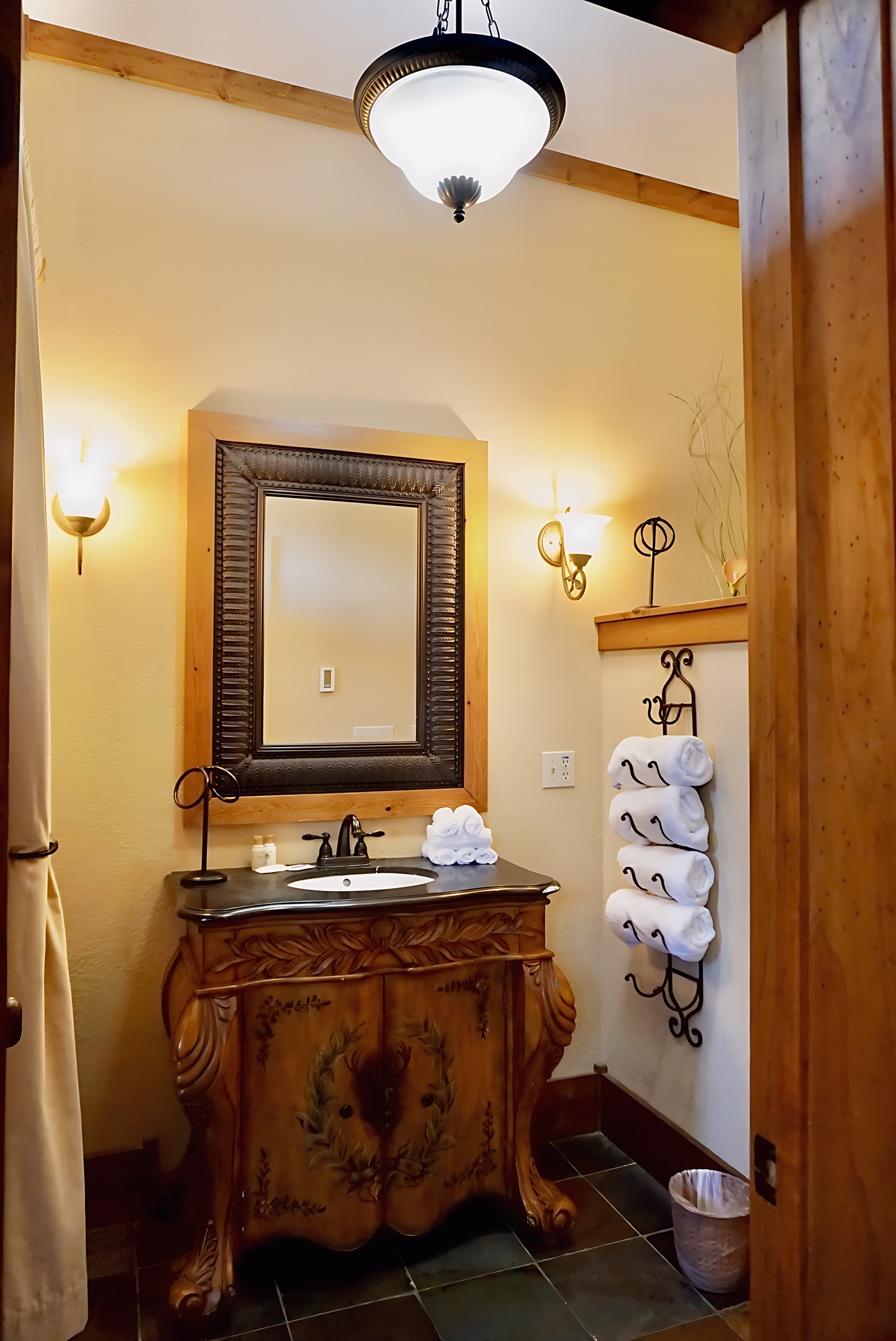 A warm and inviting bathroom, where even the towels are neatly arranged and ready for you.