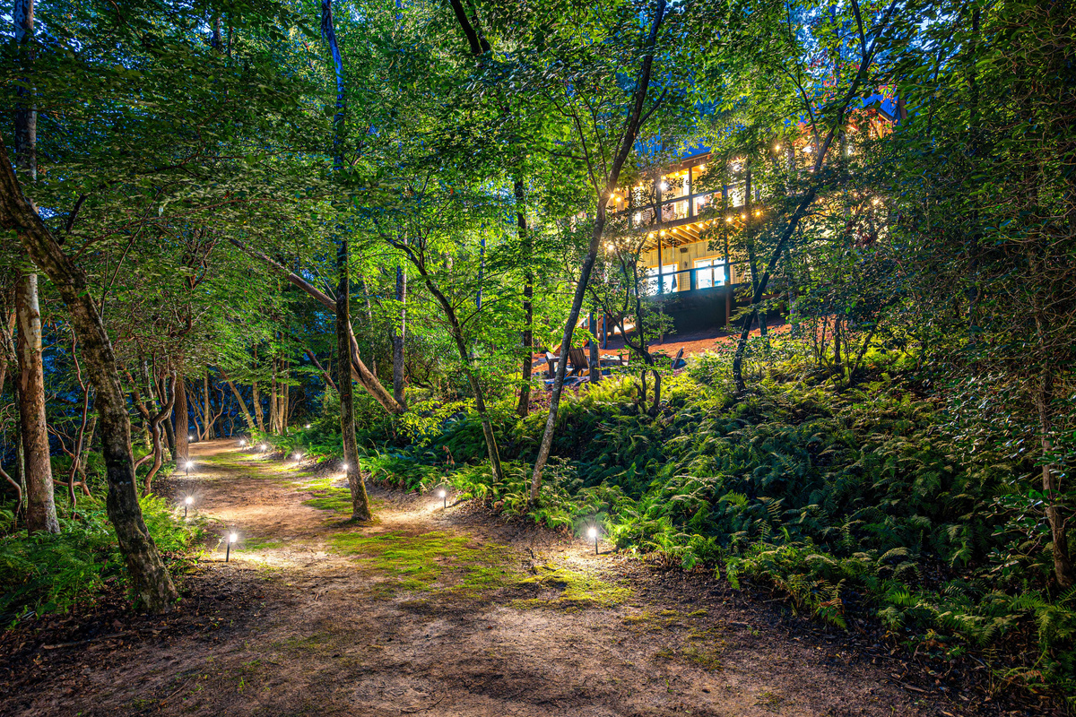 Wander through the woods as the lights guide you to the river's edge.