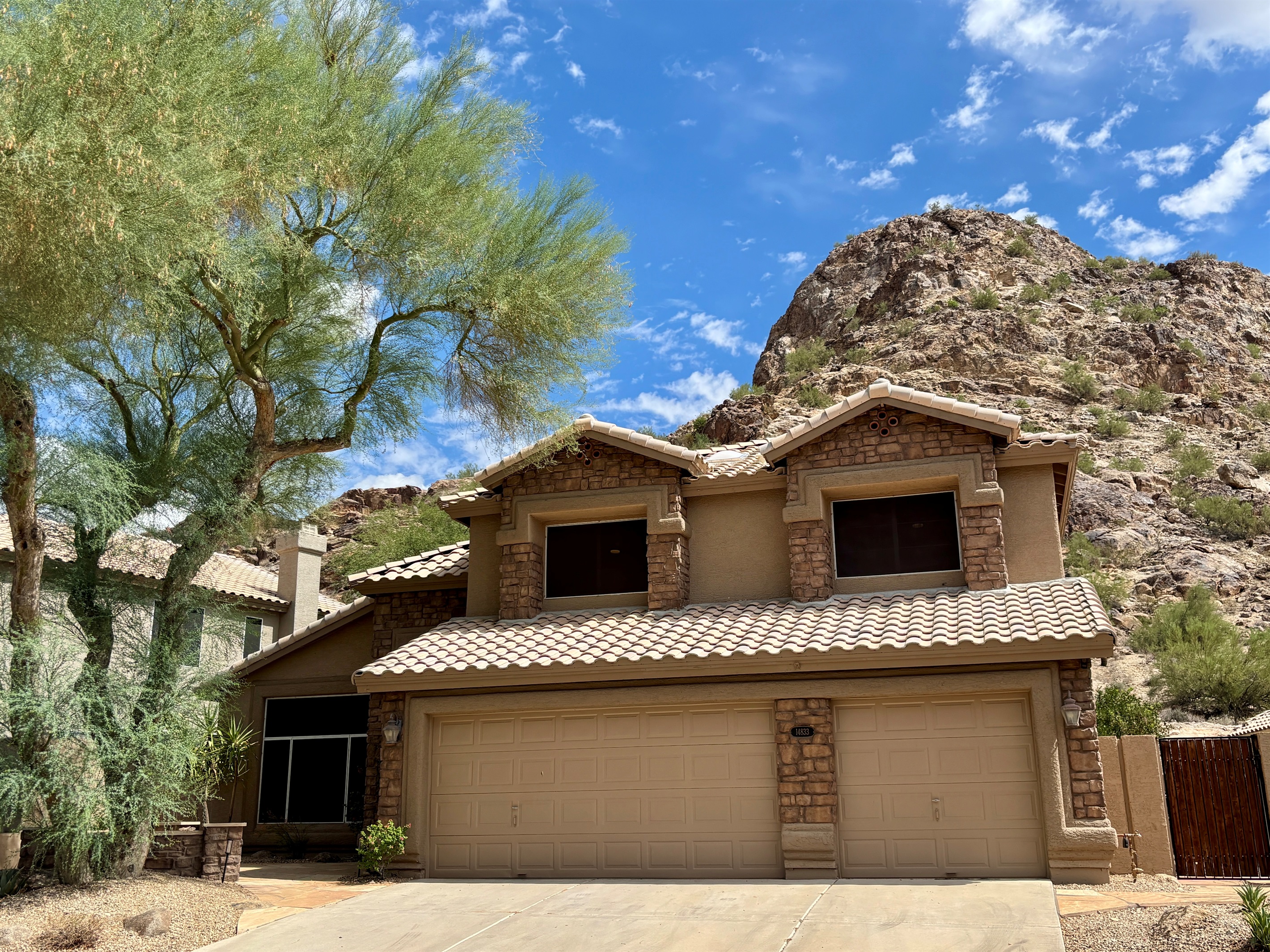 Front of house with mountain in the back