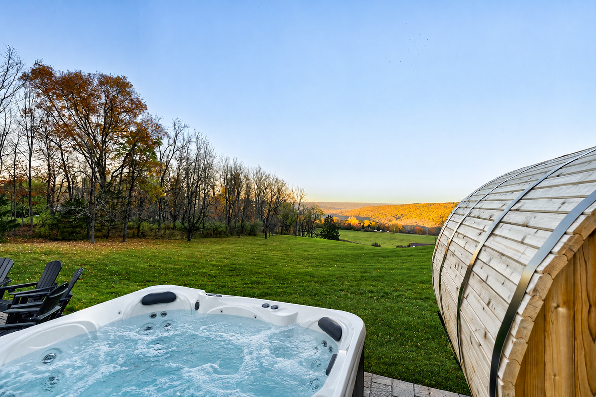 Outdoor hot tub beside the barrel sauna