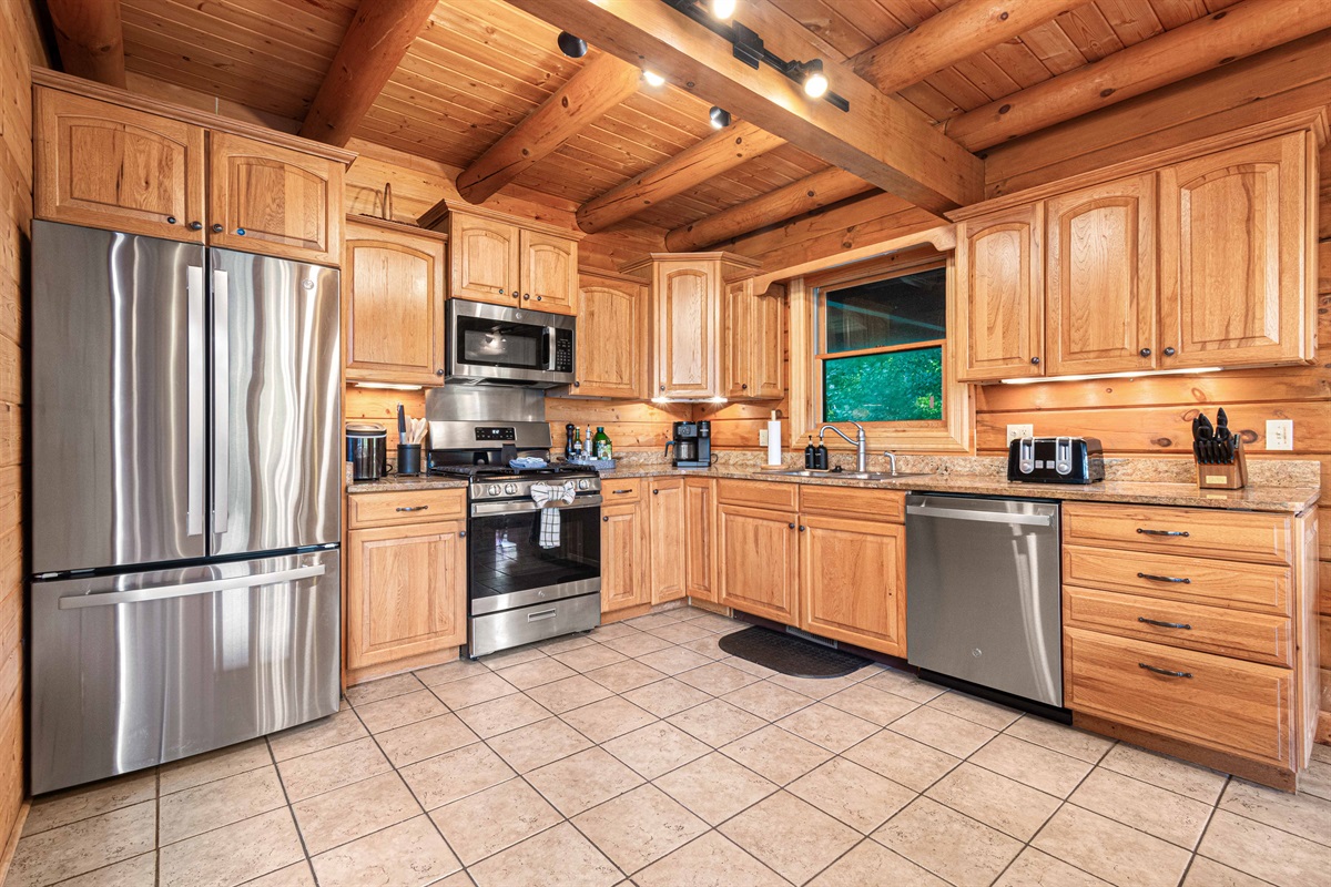 Main Level Kitchen: Chef’s paradise with modern appliances and warm, rustic charm!