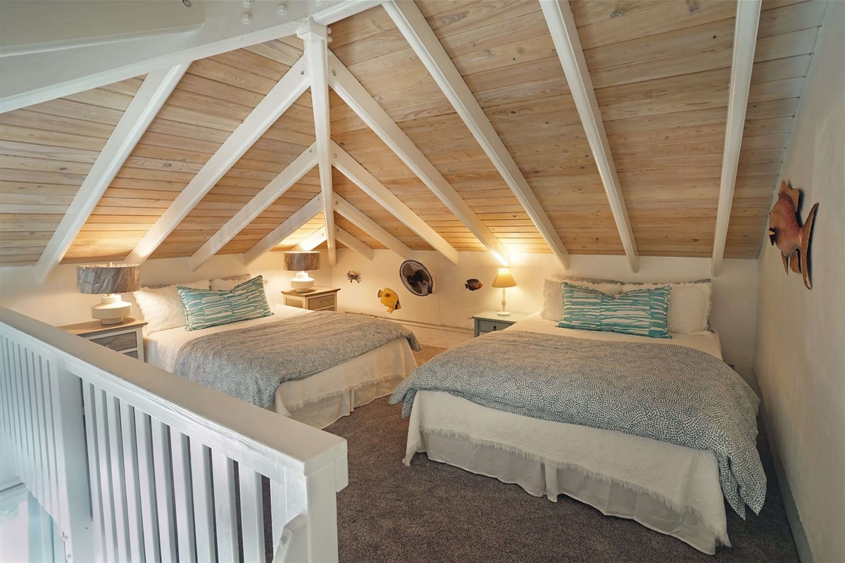 Just up the steps, you'll find two queen beds.