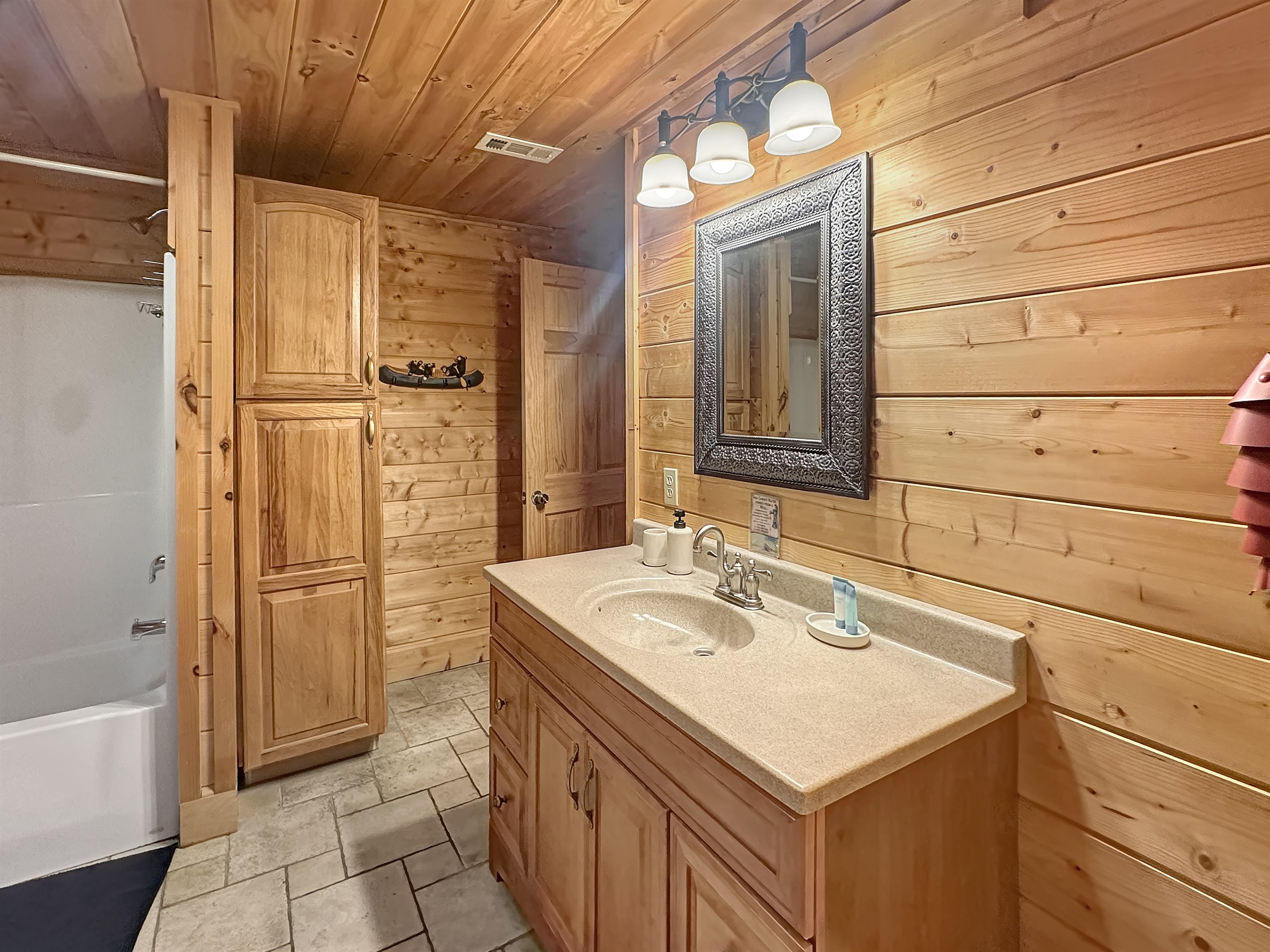 Bathroom: Experience rustic elegance with wood accents and modern amenities!