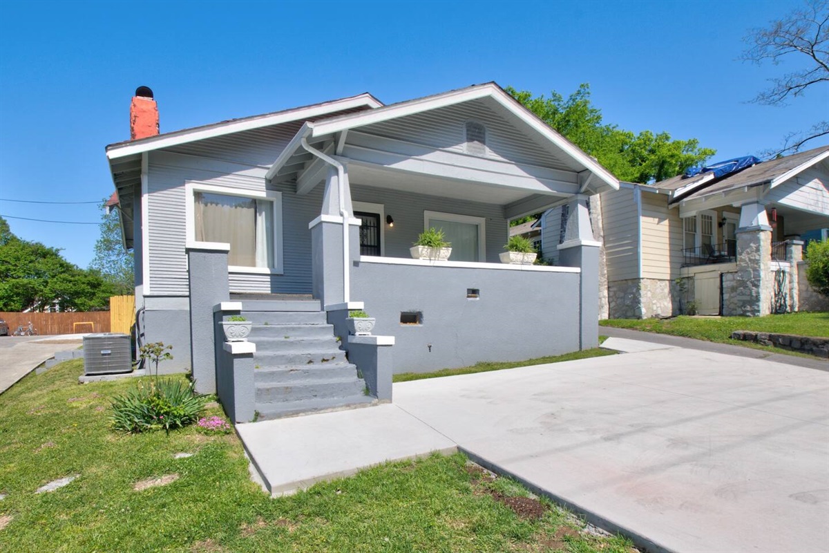 Front exterior of the house, showing private parking pad for 2 cars