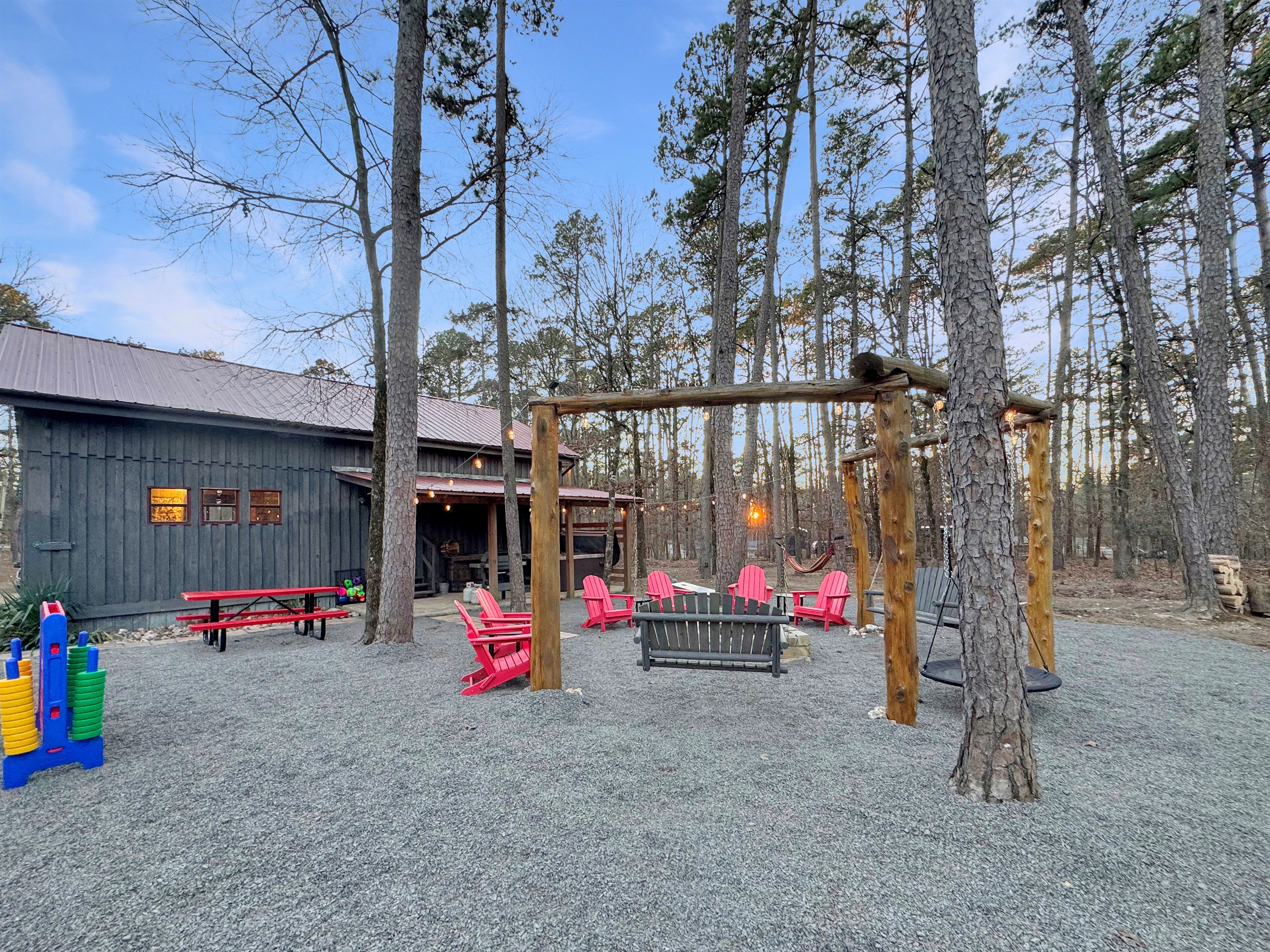 Back yard firepit, swings, playset, Connect 4, hammock, horseshoes, and grill.