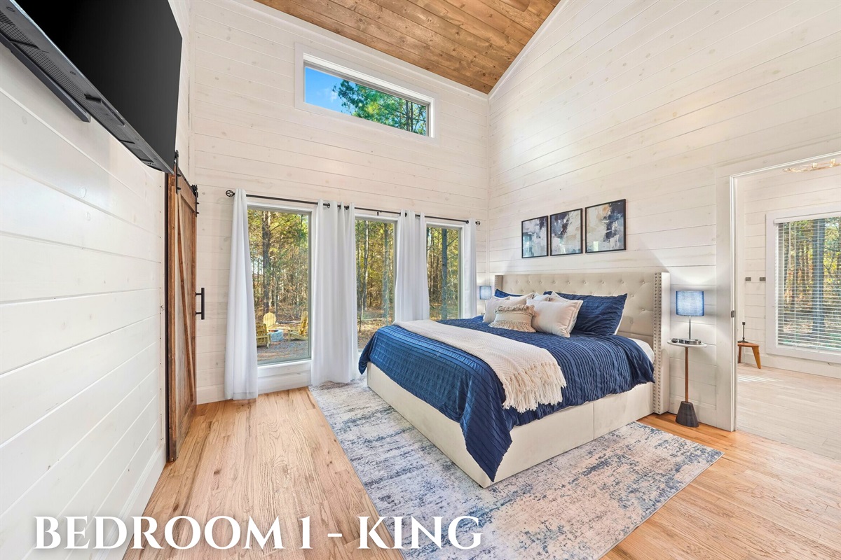 Bedroom 1 with king bed, modern design, and cozy ambiance.