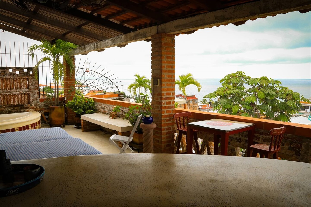 Private covered roof top terrace with the best views of the Bay of Banderas and Old Town. Terrace includes a jetted tub, bar, and 2 lounge chairs to relax in.