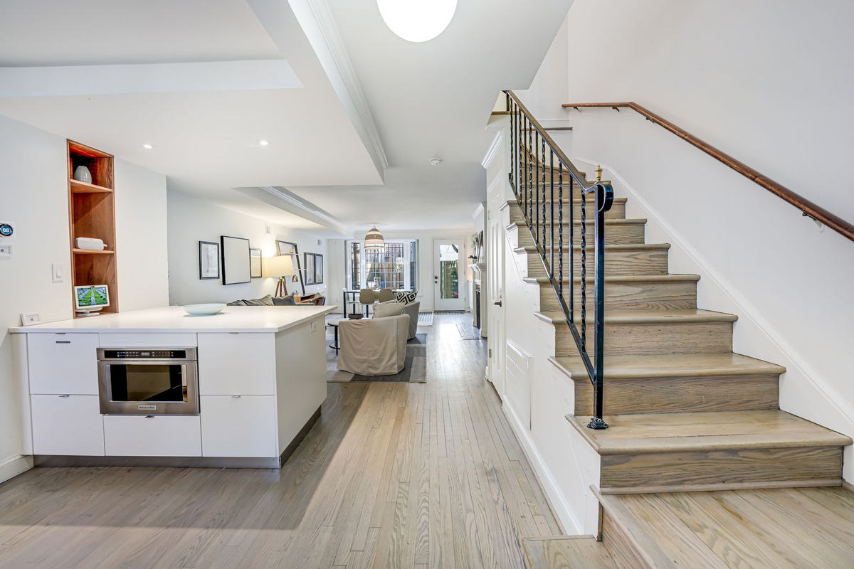 Kitchen Island, Living/Dining Room, Rear Door to Patio, Stairs to 2nd Floor.