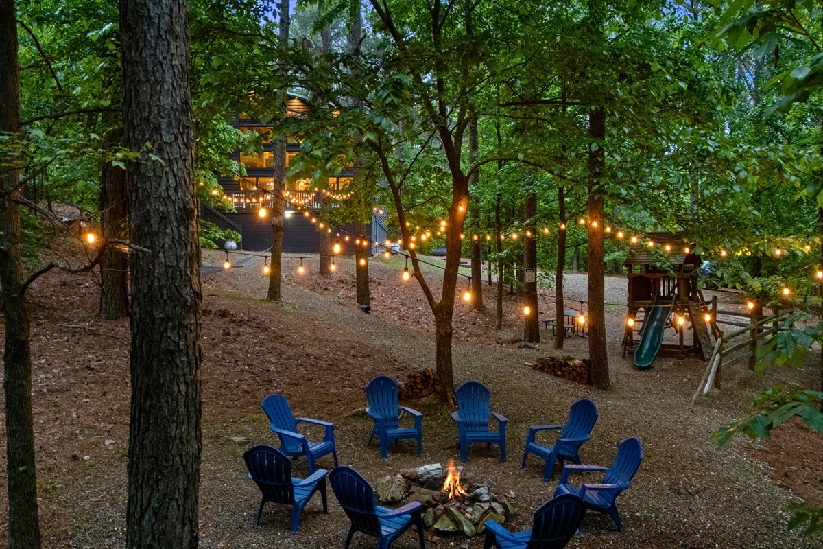 At night, the fire pit area glows under the string lights, creating a cozy atmosphere that’s hard to leave.