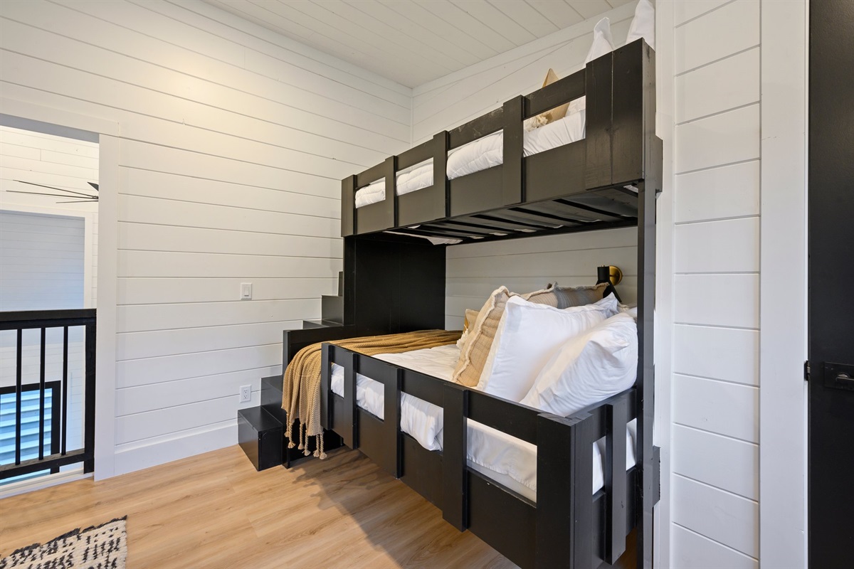 Custom bunk beds with built-in stairs make this space perfect for kids and teens.