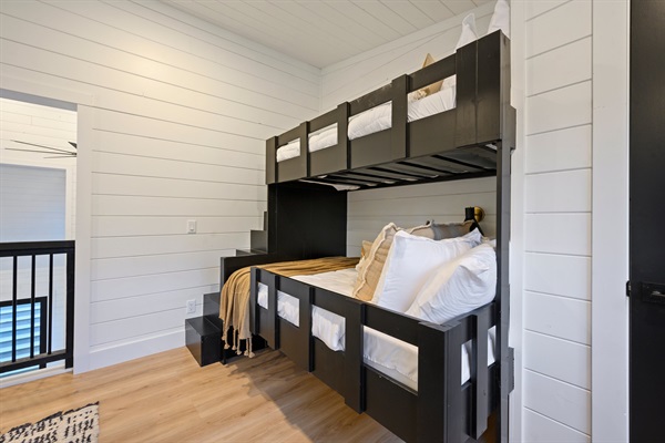 Custom bunk beds with built-in stairs make this space perfect for kids and teens.
