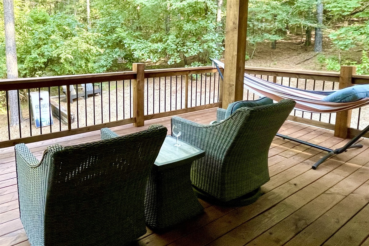 Watch the sunset over the cabin from these rocking swivel chairs or the double hammock.