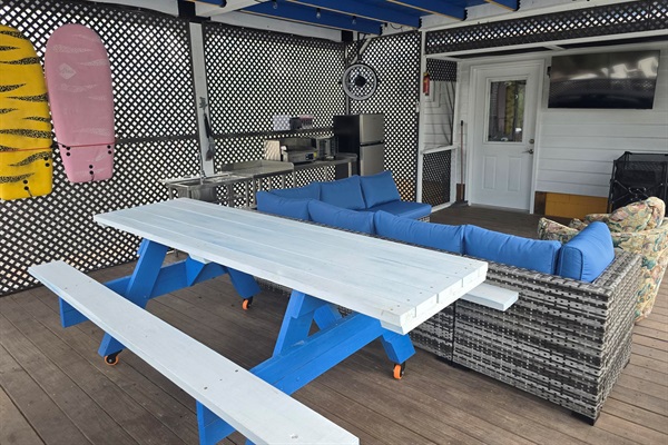 An oversized picnic table is also in the screened patio