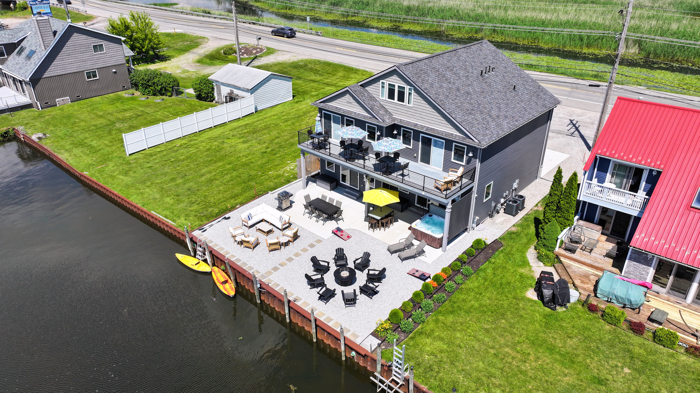 This private canal-front getaway features expansive outdoor living spaces, a private dock, kayaks, hot tub, fire table, and easy access to the lake's popular sandy swimming area—all designed for unforgettable waterfront memories.