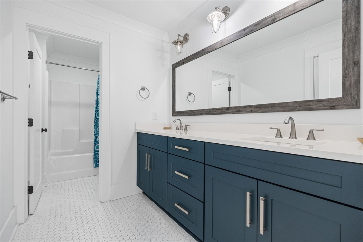 1st Level Pool Bathroom &ndash; Spacious private bath with dual vanity, combo tub/shower, separate shower, and toilet