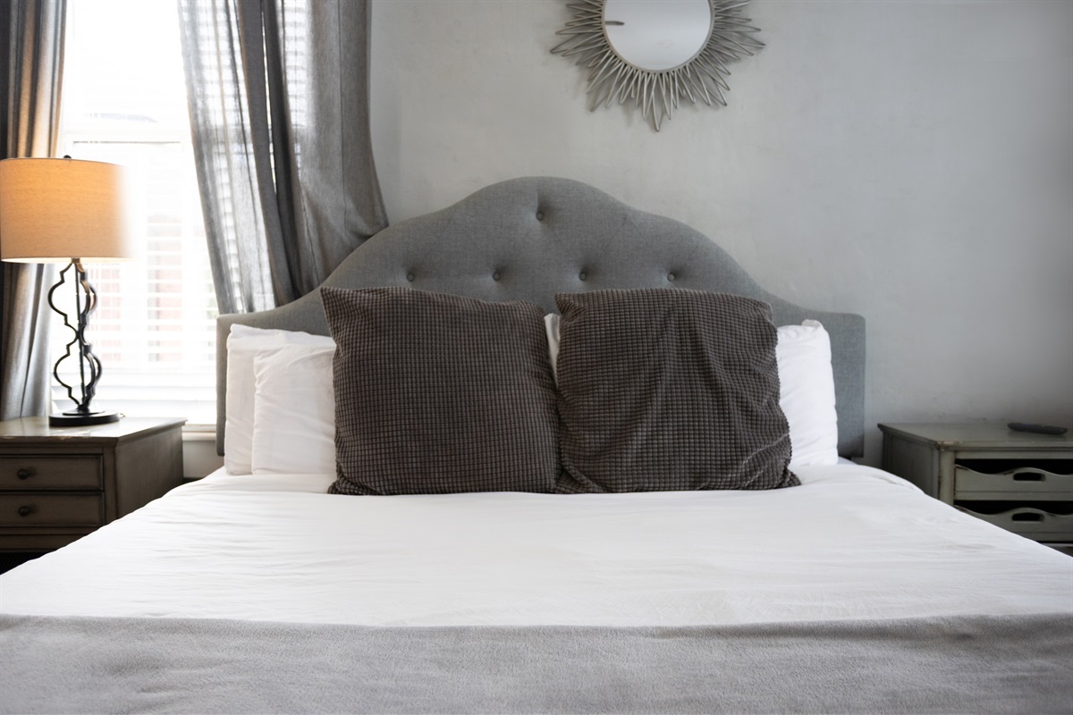 Natural light and plush bedding make this room a peaceful retreat.