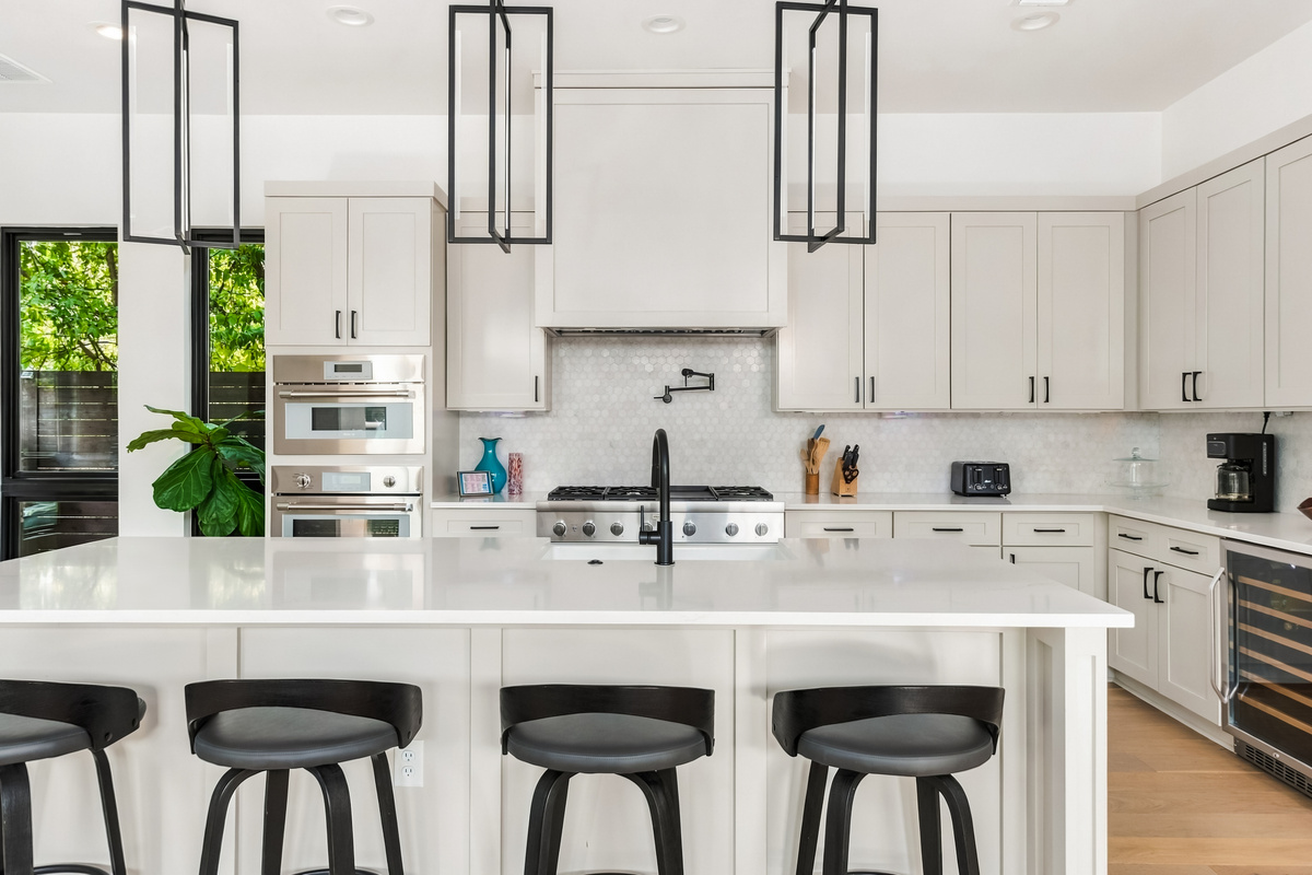 Statement pendant lighting anchors this bright, open-concept kitchen.