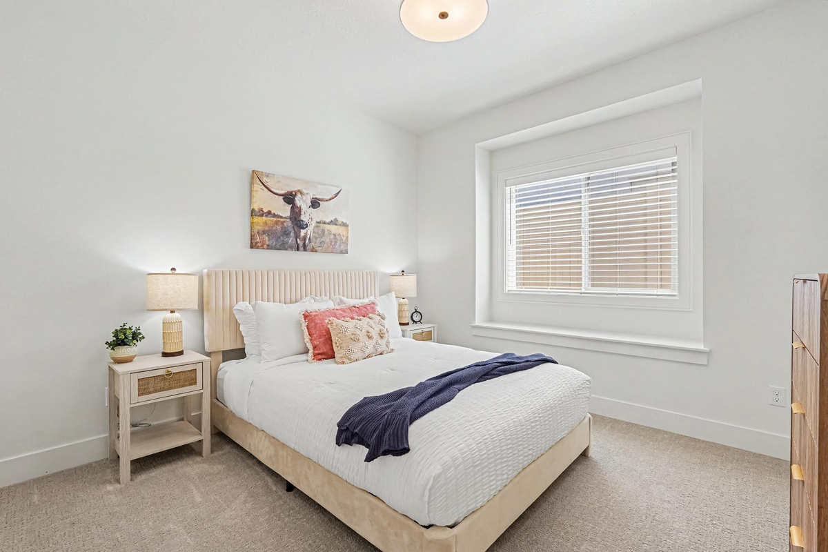 Relax and recharge in the middle bedroom with a cozy queen bed and thoughtful touches for your comfort.