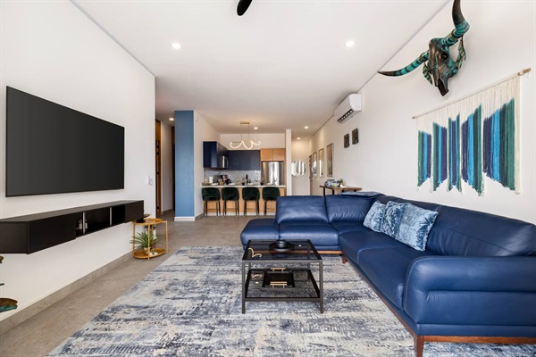 Enjoy the stunning view from the living room sliding glass door, seamlessly connecting the cozy living room and modern kitchen.
