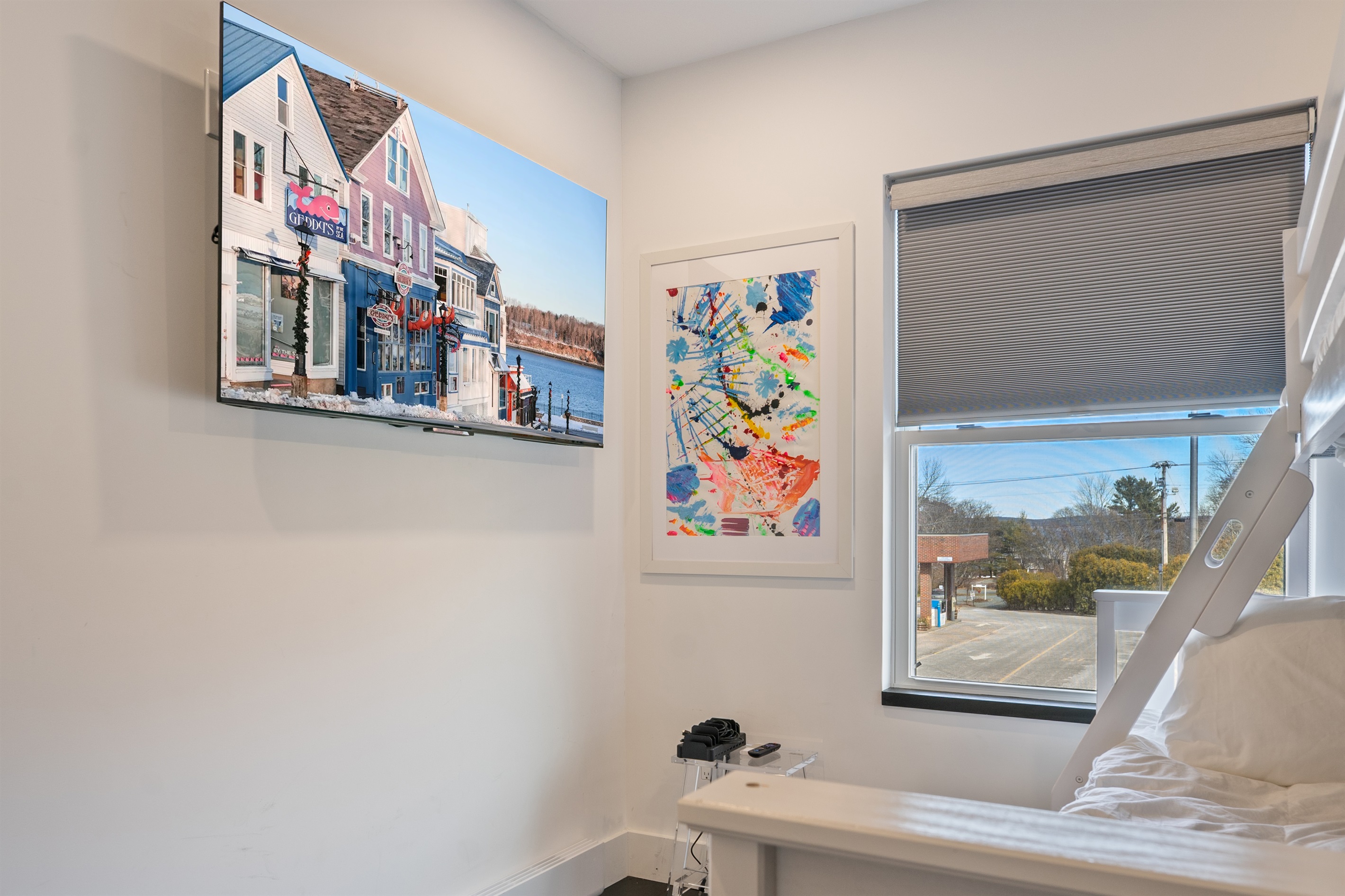 High-definition 55-inch Roku Smart TV in the family bunk room. Enjoy your favorite streaming services with ease. This thoughtful detail ensures every guest has access to top-tier entertainment in the absolute heart of downtown Bar Harbor.