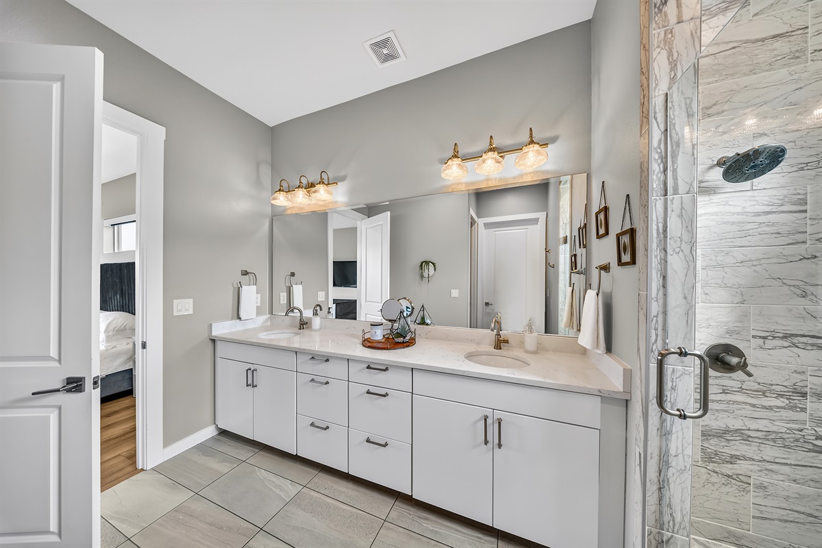 - Spacious bathroom with double vanity offers bright, relaxing comfort - Large mirror and soft lighting enhance your morning lake getaway - Easy access to bedroom adds convenience during your peaceful stay