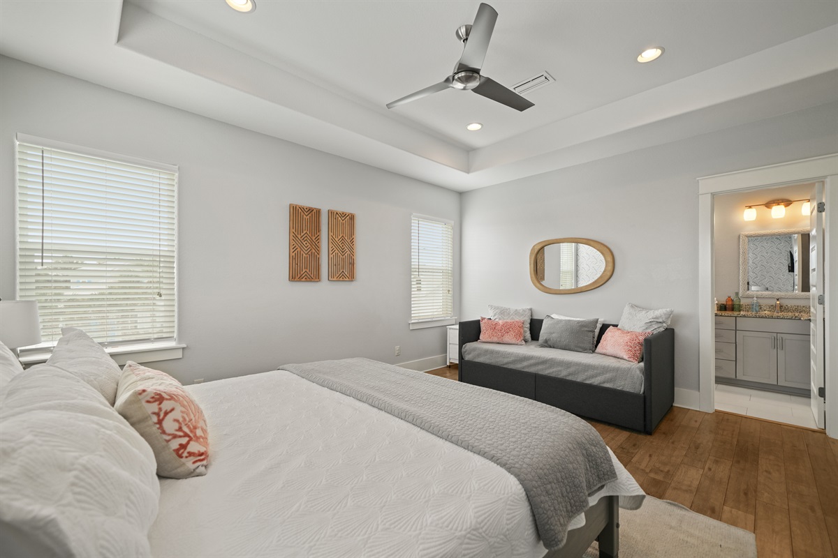 Grand Master King Suite with king bed, tray ceiling, ceiling fan, and seating area.