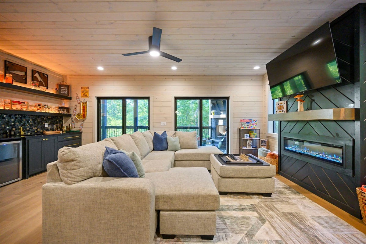 Game room couch features an ottoman with storage that can also be used as a game table with drink holders.  Perfect for a board game, or a game of chess!