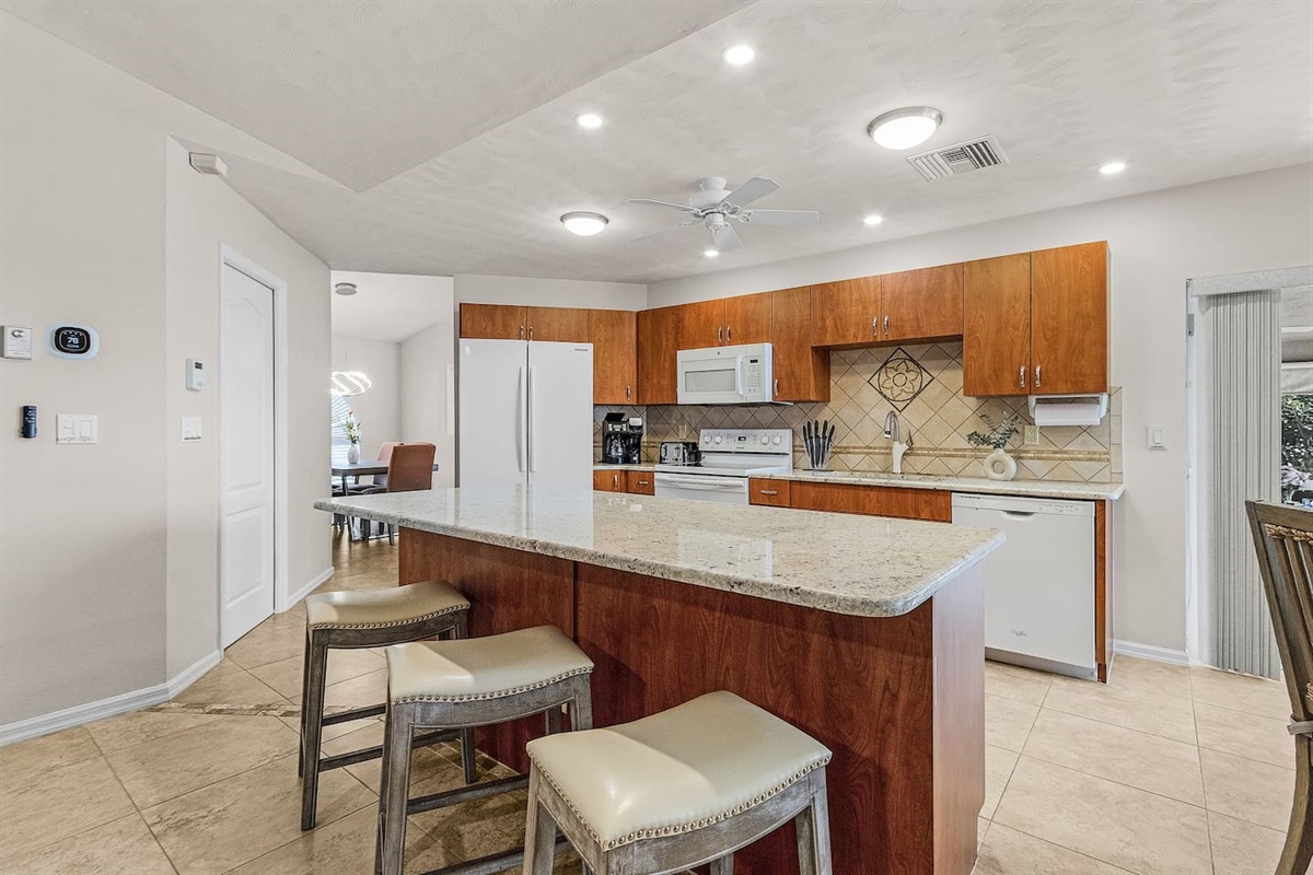 Bright and open kitchen with a generous island for prep and dining!