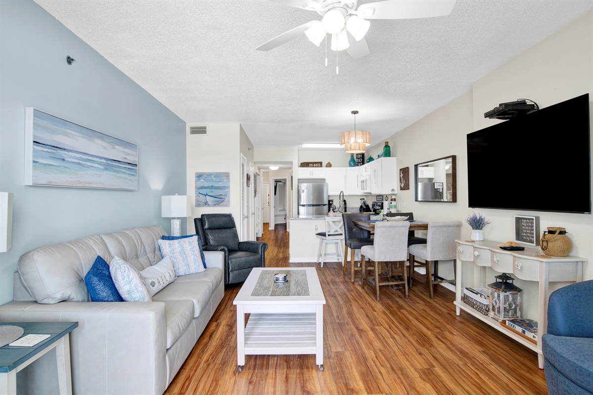 Living room with sleeper sofa, recliner, arm chair, ceiling fan, wall mounted Smart TV and a great Gulf and beach view 